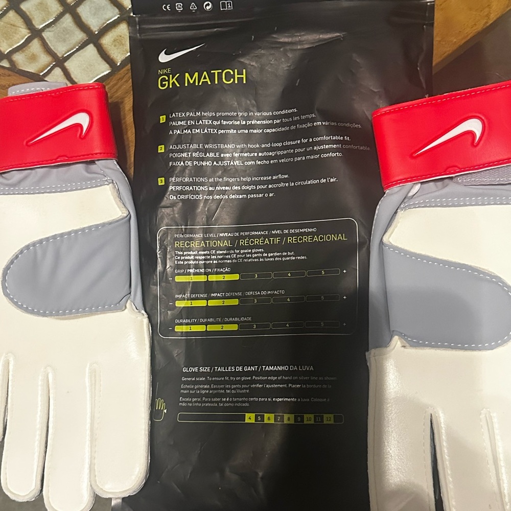 Red Game Day Nike goal keeper gloves. Too large so never used.